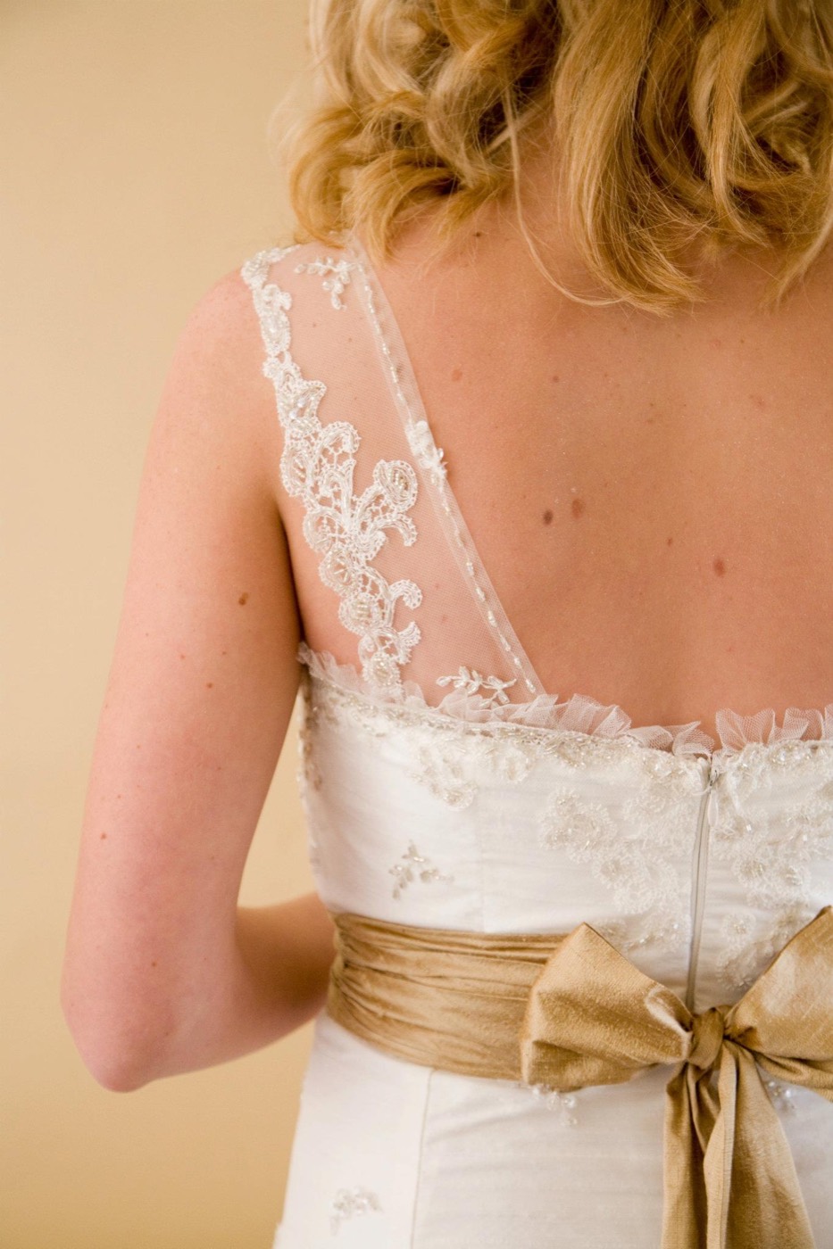Beaded lace straps across the open back of a bridal gown