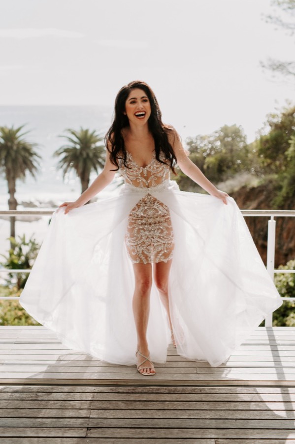 Beaded high-low gown with a sheer overlay and structured bodice
