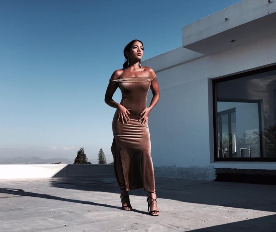 Sheer knitted column dress photographed against a white wall