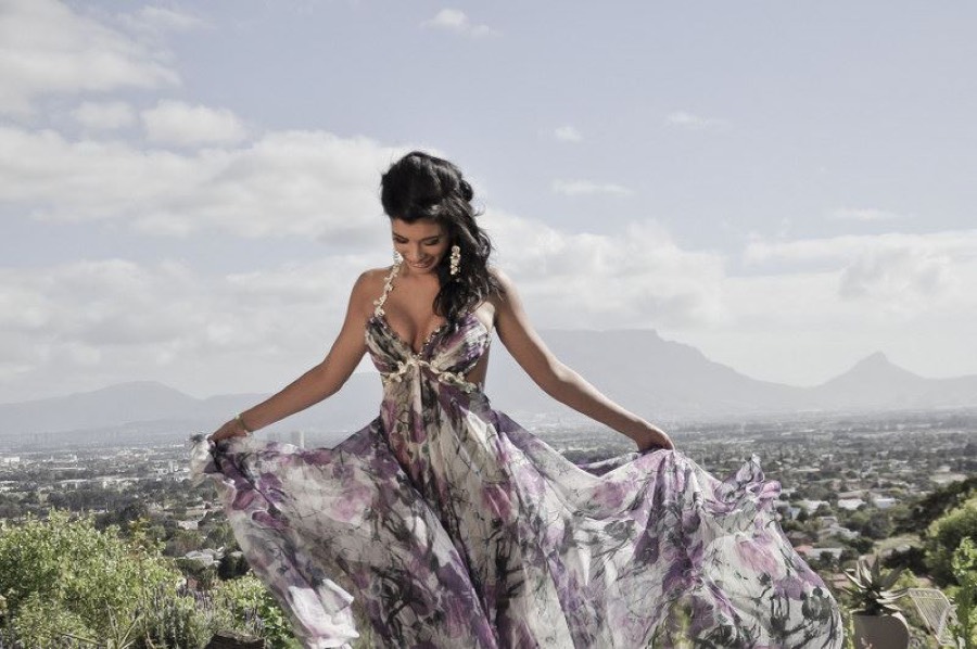 Floral chiffon gown lifted into the wind above the Cape Town valley