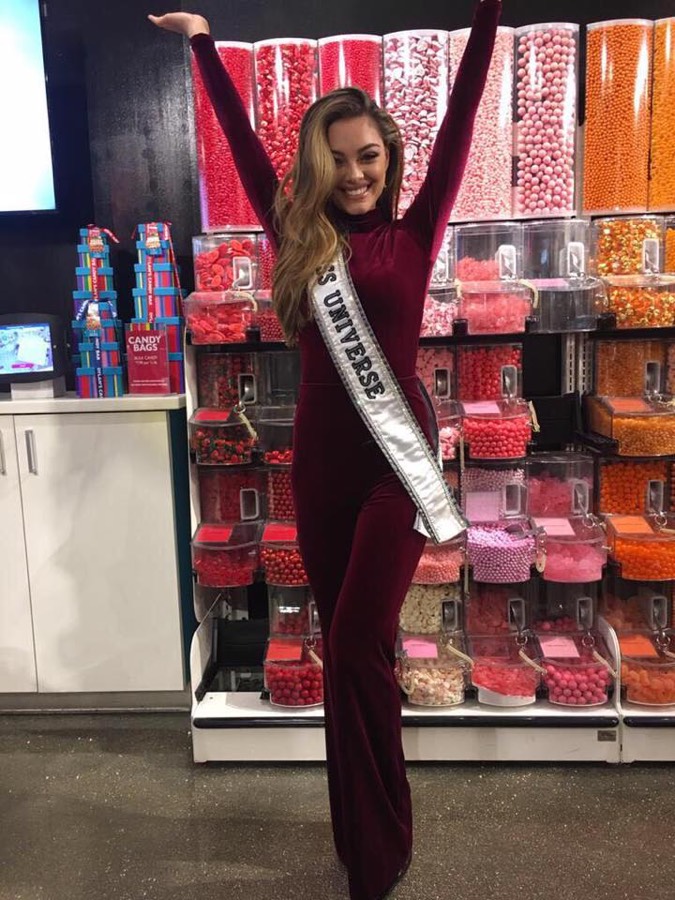 Pageant sash worn over a deep burgundy gown